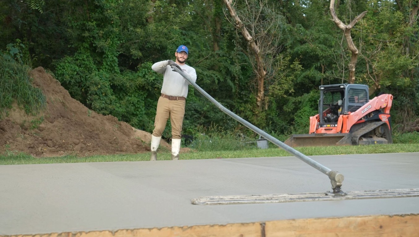 Commercial concrete contractor smoothing large outdoor slab